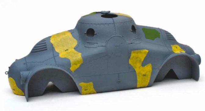 Above: 
After priming the model, the entire model was airbrushed in two light coats of Tamiya Medium Grey XF-20. Once dry, a few pre-cut templates were added to protect the grey from subsequent paint.